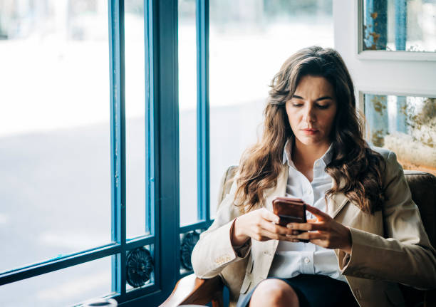 istock Businesswoman text messaging through cellphone 1191604523