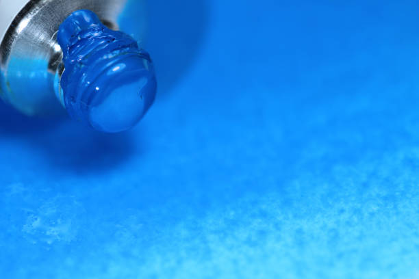 istock Cerulean blue Watercolor paint tubes on hand painted background. 1191604607