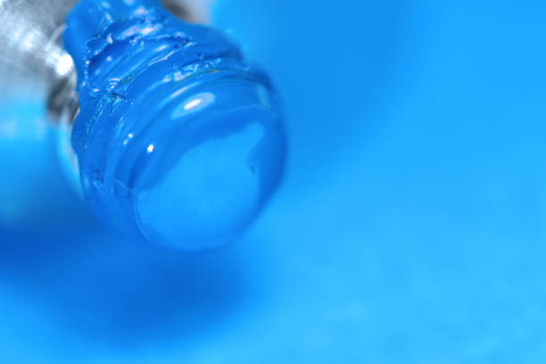 istock Cerulean blue Watercolor paint tubes on hand painted background. 1191605363