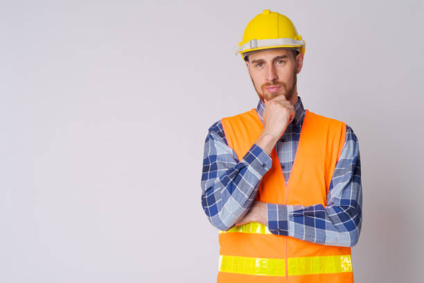 istock Portrait of young bearded man construction worker thinking 1191605730