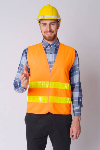 istock Happy young bearded man construction worker giving handshake 1191605770