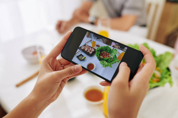istock Woman photographing dishes 1191605998