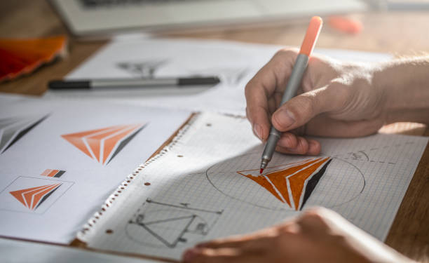 istock Graphic designer drawing sketches logo design. 1191607185