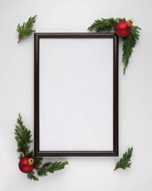istock Christmas or New Year composition. Photo frame with copy space, Christmas tree branches and Christmas balls on white background. Flat lay, top view, vertical layout 1191607607