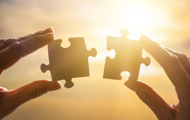 istock The man holds in his hand a jigsaw puzzle. 1191608038