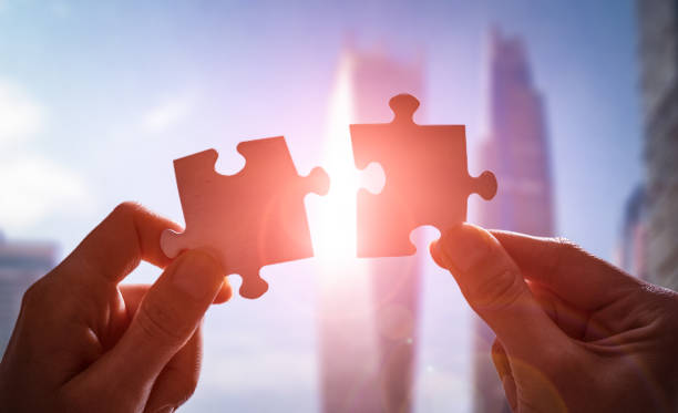 istock The man holds in his hand a jigsaw puzzle. 1191608982
