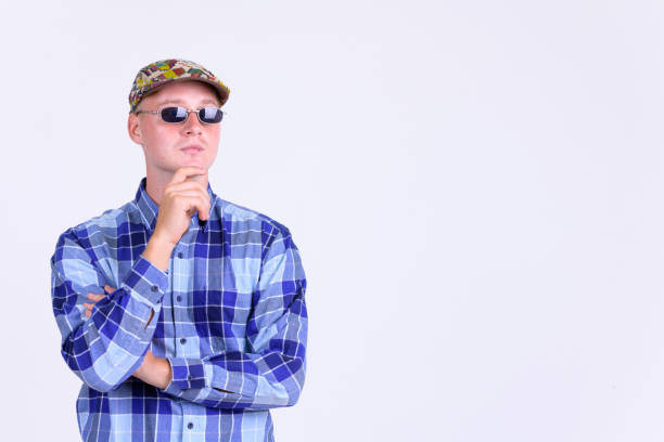 Studio shot of young handsome hipster man as artist against white background