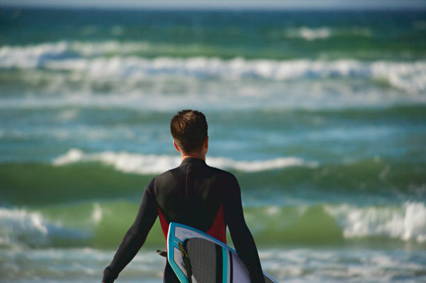 istock Surfer running into the water 1191613522