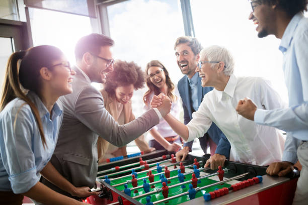 istock Employees playing table soccer indoor game in the office during break time 1191616625