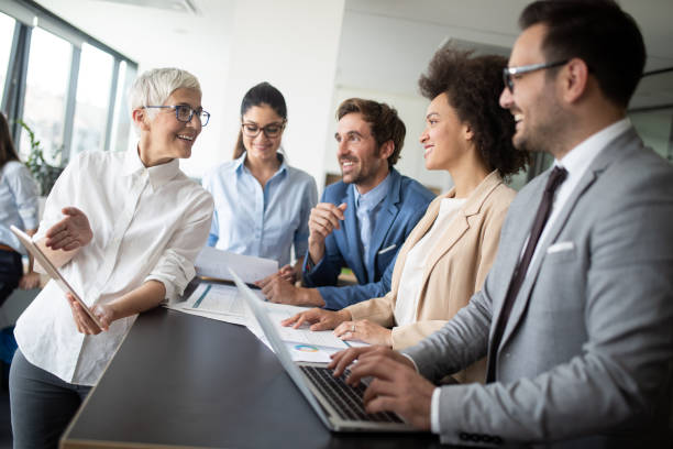 istock Happy business colleagues in modern office working together 1191616698
