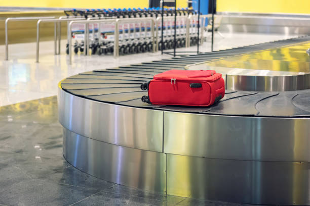 istock Red suitcase at airport 1191619958