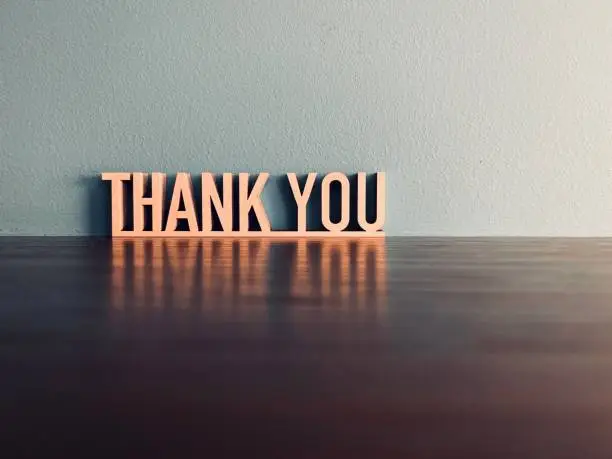 Photo of THANK YOU phrase on blue background