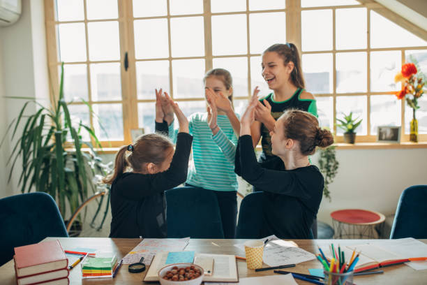istock Young girls students having fun on class in private school 1191625145