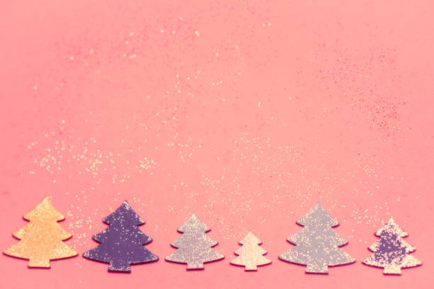 istock Christmas decoration, trees on pink background 1191625525