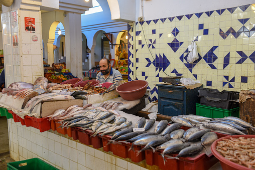 Sousse, Tunisia -  7 November 2019: people selling fish at the market on the medina of Sousse in Tunisia