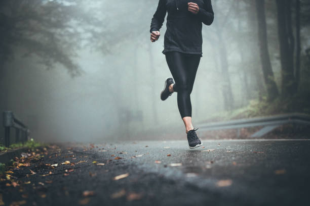 istock Unrecognizable athlete running on misty autumn day in the forest. 1191626642