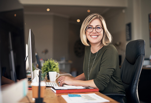 Shot of a young businesswoman using a computer in a modern office