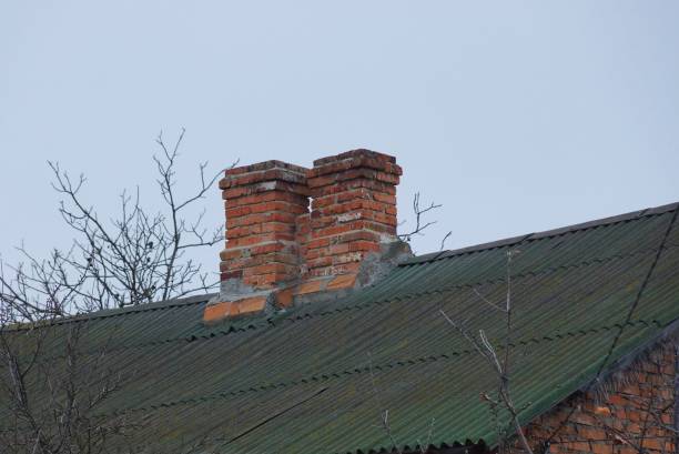 istock two brown old chimneys on a slate green roof 1191628522