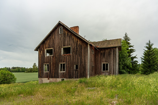 Old creepy abandoned house on the Swedish countryside, standing alone all run downed and worn