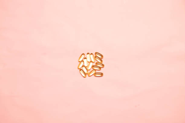 istock Top view of assorted multi-colored medical capsules, tablets on a pink background. Dietary supplements and diet concept 1191630019
