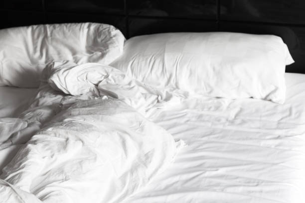 istock Crumpled blanket and pillows in a bed 1191631858