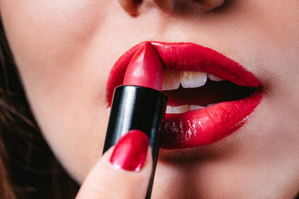 istock Woman applying lipstick 1191632582