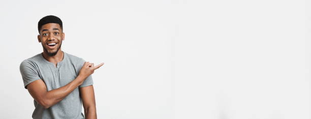 istock Excited african american guy pointing aside at empty space 1191632970