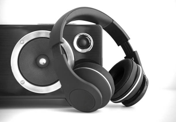 Wireless headphones and speaker box on white background