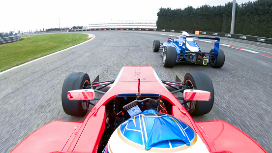 Formula racing cars driving on the track.