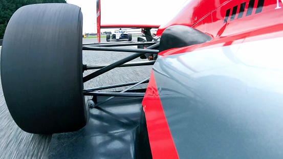 Close up of Formula racing car driving on the track.