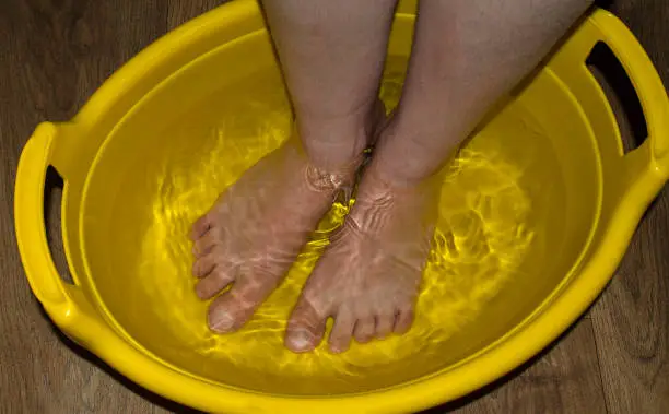 Steaming legs in a bowl of hot water