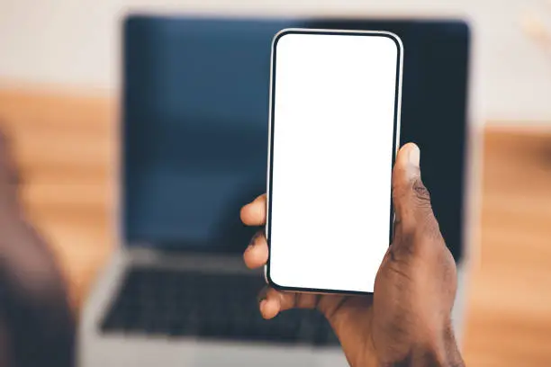 Photo of African american using black phone with blank screen