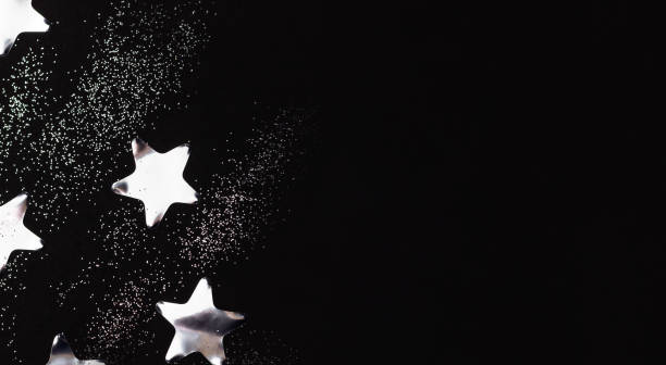 istock Silver stars and sparkles on black background. Flat lay, copy space. 1191635098