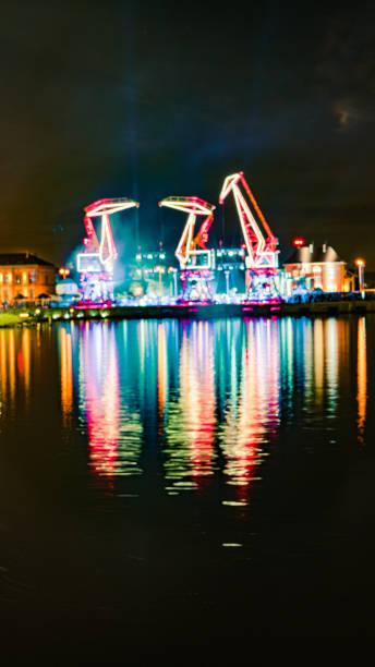 illuminations in the polish city of szczecin, ferris wheel at night - laser firework display performance showing imagens e fotografias de stock