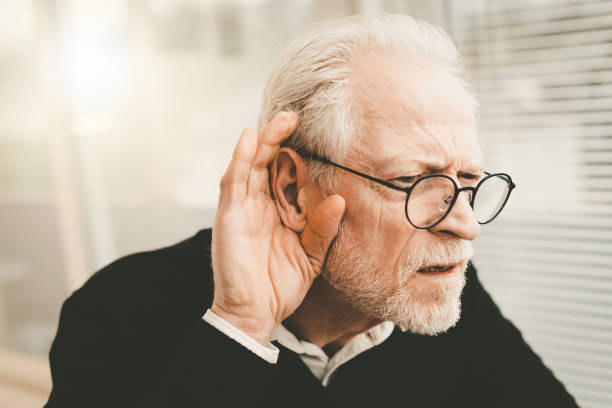 Senior man with hearing problems stock photo