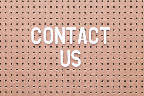 istock Words Contact us made from white letters on brown pegboard, horizontal 1191637907
