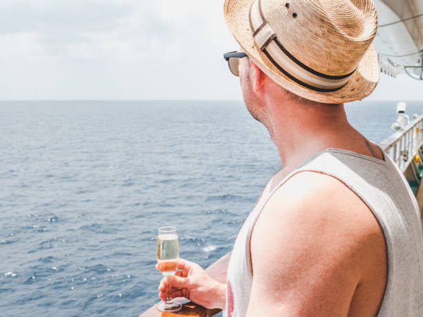 istock Man holding glass on the open deck 1191638237
