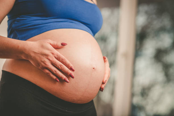 istock Pregnant woman with hands on her belly 1191638285