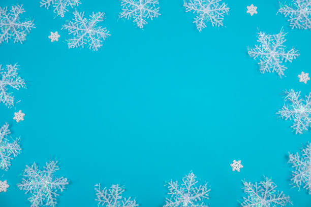 istock Creative Christmas layout. Snowflakes on blue background with copy space. 1191638336