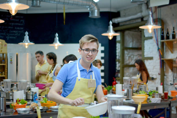 istock Cooking class. young happy friends in the kitchen 1191638343