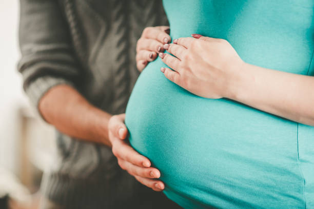 istock Couple with hands on pregnant belly 1191639111