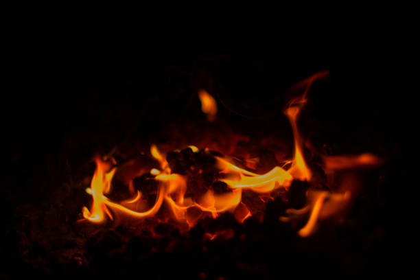 Colorful flames from a hot coal fire in a blacksmith's fireplace close up.