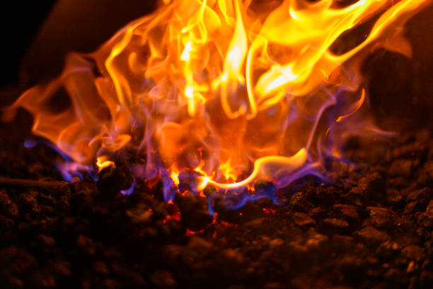 istock Colorful flames from a hot coal fire in a fireplace close up 1191639586