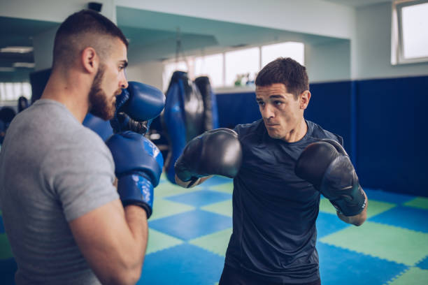 istock Two MMA fighters sparing in gym 1191641147