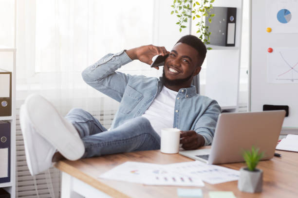 istock Confident young businessman resting at workplace with his legs on table 1191642009
