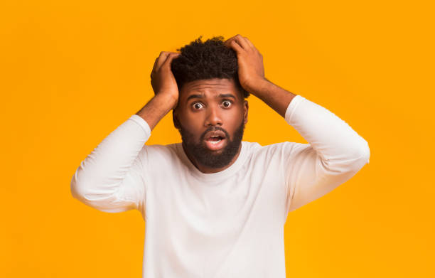 istock Shocked black guy with open mouth touching his head 1191642915