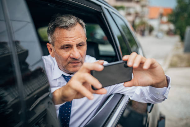 istock Man taking photos from the car while driving 1191644932