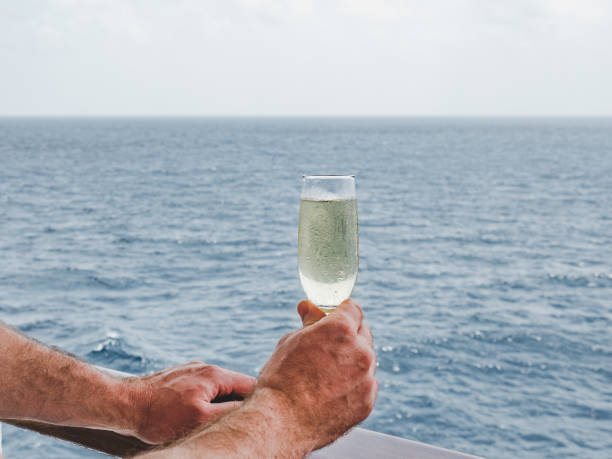 istock Man holding glass on the open deck 1191645944