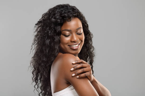 beautiful afro girl touching her soft skin on body - sensuality horizontal indoors studio shot imagens e fotografias de stock