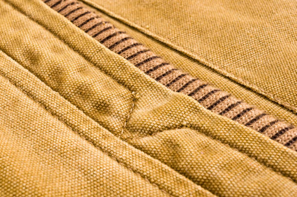 istock clothing items stonewashed cotton fabric texture with seams, clasps, buttons and rivets, macro 1191648496